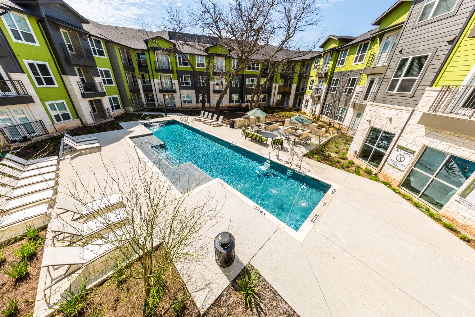Pool overview with poolside seating, and BBQ area