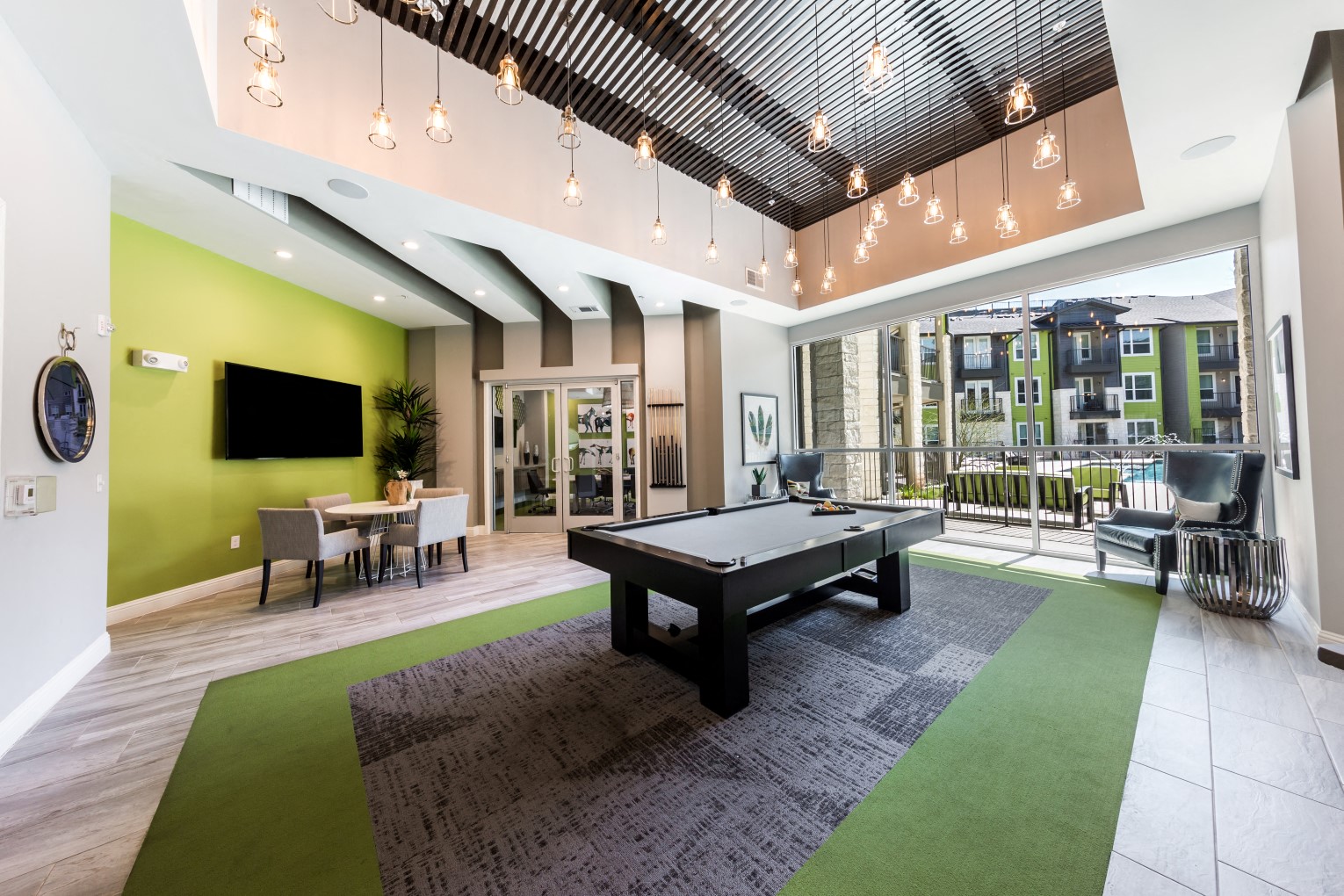 Game lounge with pool table and pool view