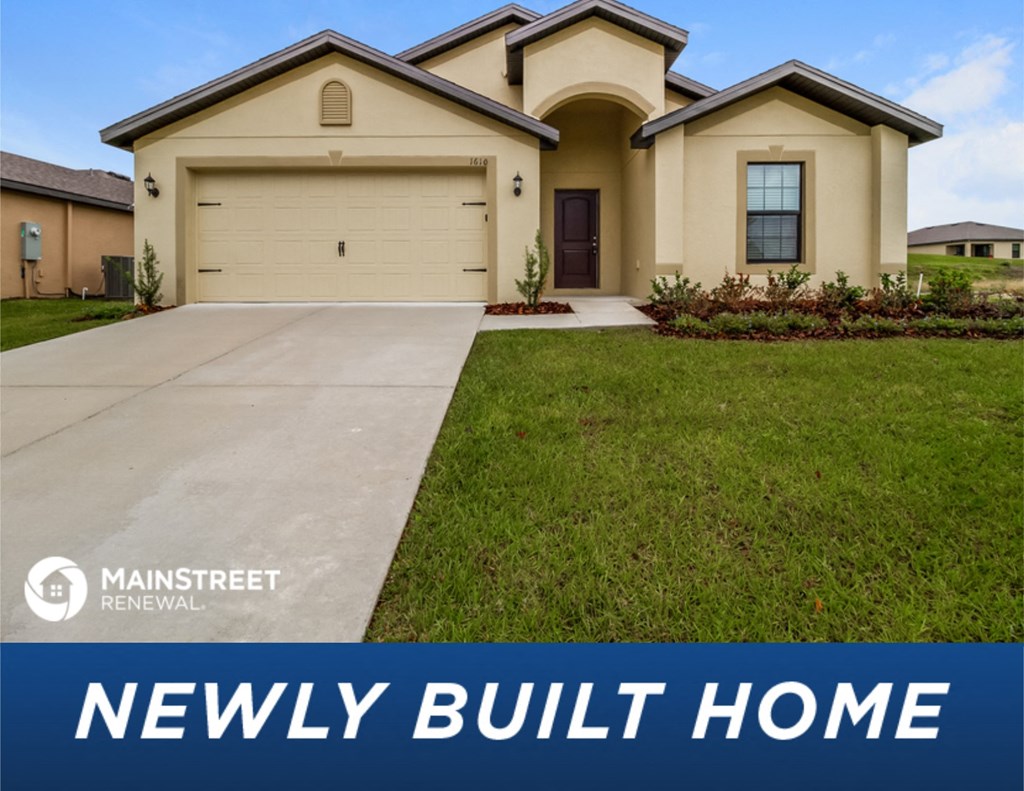 a new build home in front of a lawn and a driveway
