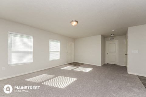 the spacious living room and dining room in this manufactured home
