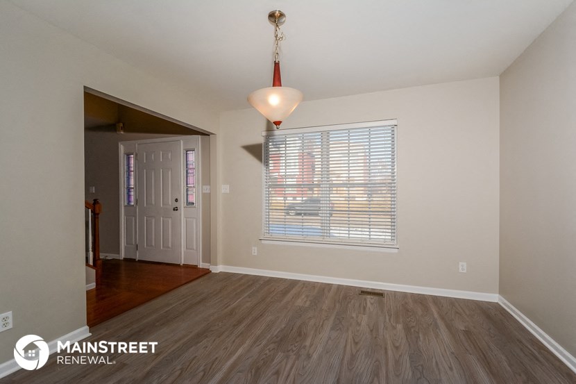 the living room and dining room of an empty renovated house