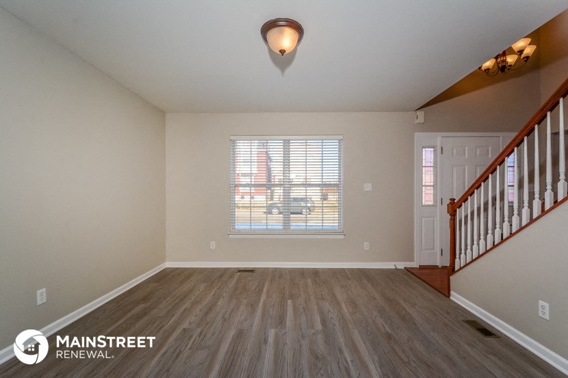 the spacious living room with stairs to the bonus room