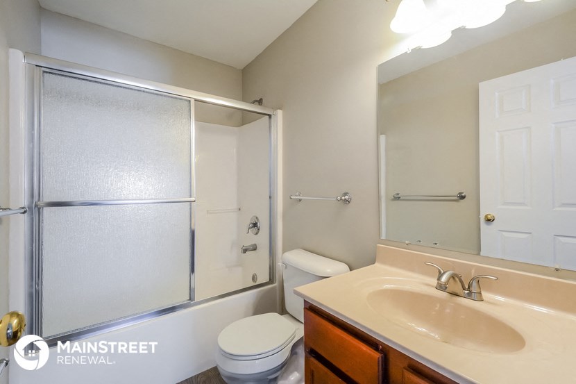 a bathroom with a sink and a shower and a toilet