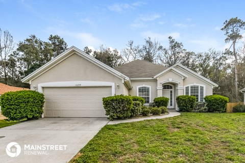 a home with a driveway and a lawn
