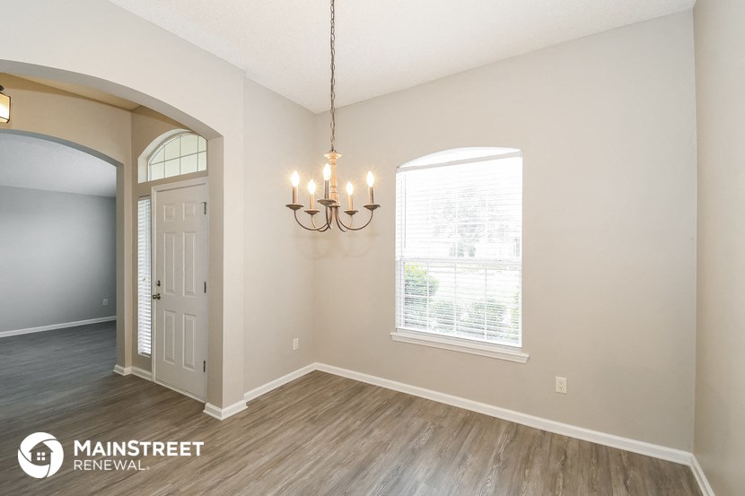 the living room of a home with a door and a window
