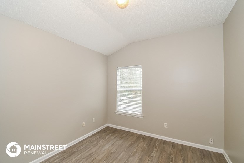 the upstairs bedroom of this 2500 sq ft home has hardwood flooring