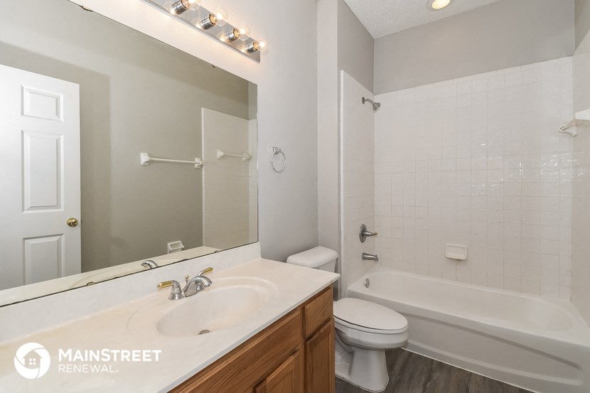 a bathroom with a sink and a toilet and a tub