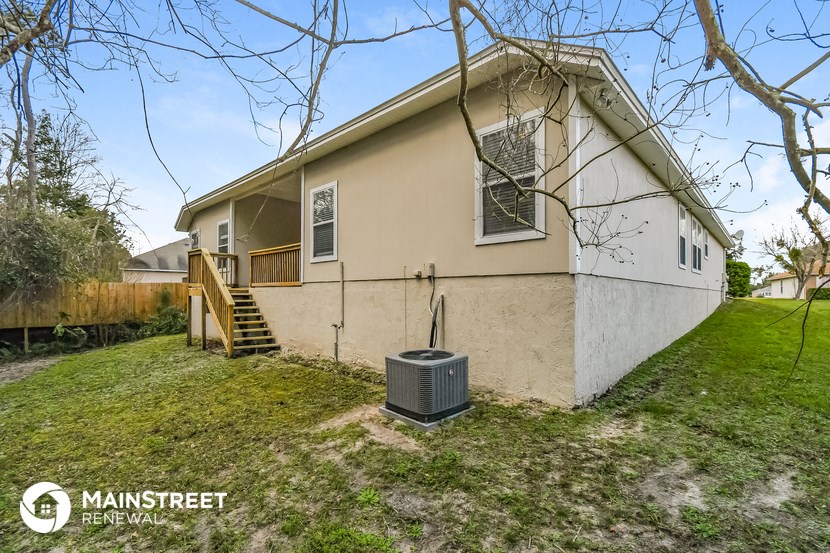 the front of a house with a heater in the yard