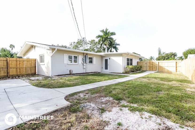 a white house with a yard and a sidewalk