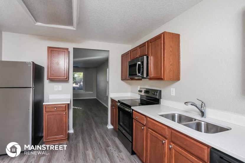 the kitchen of our studio apartment atrium with stainless steel appliances and wooden cabinets