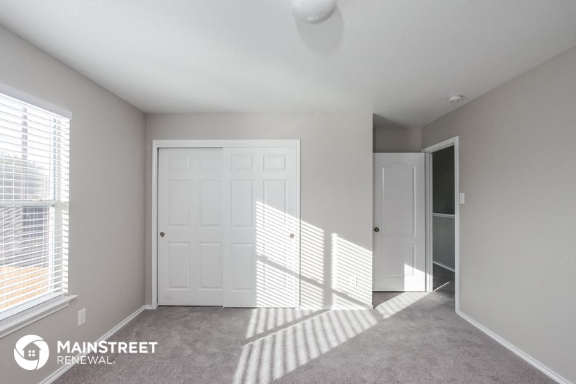 a master bedroom with a closet and a white door
