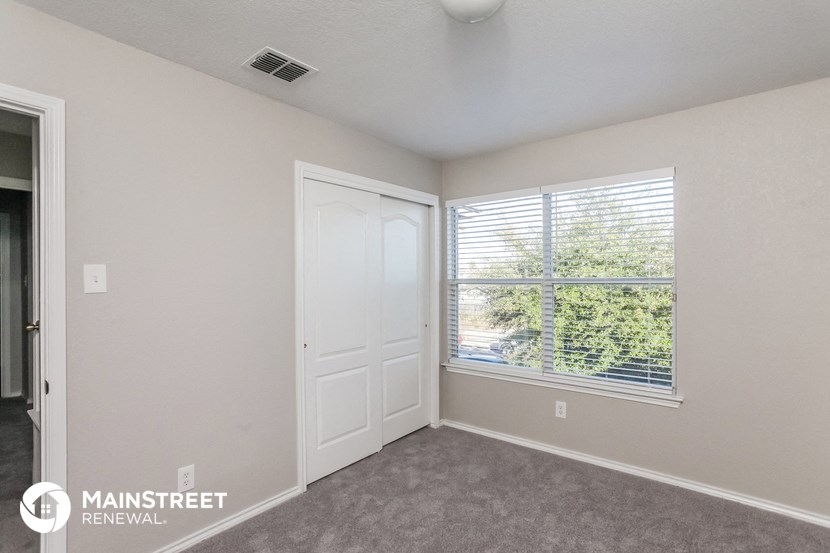 the living room of an apartment with a large window