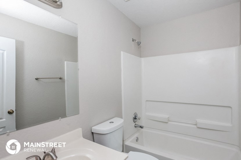 a bathroom with a sink and a toilet and a bath tub