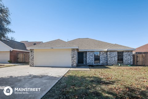 front view of a home with a garage door and a lawn