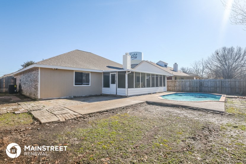 a backyard with a pool and a house