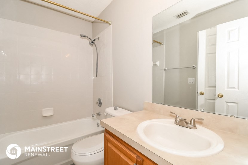 a bathroom with a sink and a toilet and a shower