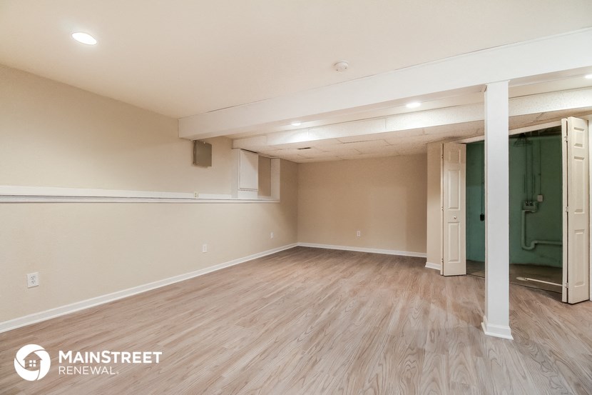a living room with a wood floor and a green closet