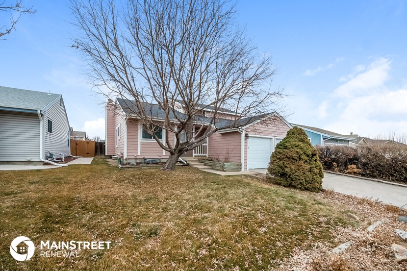 a pink house with a tree in front of it