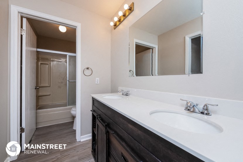 a bathroom with a sink and a mirror and a shower