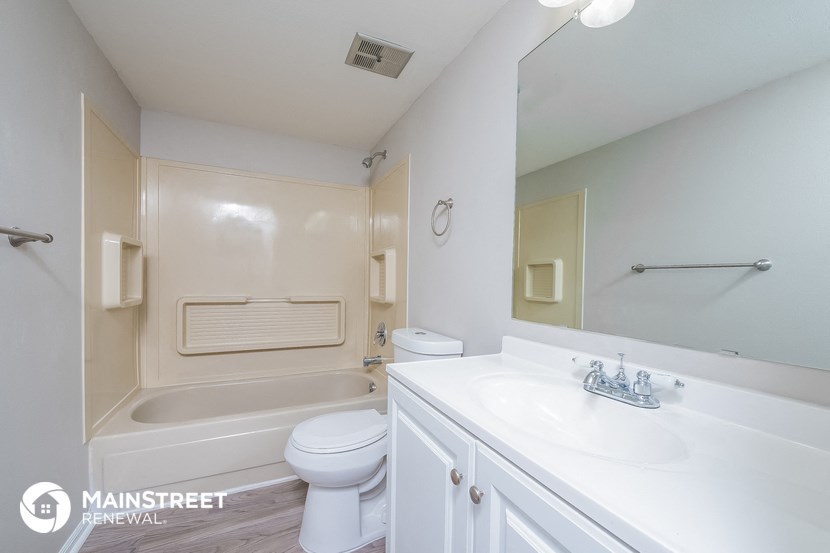 a bathroom with a sink and a toilet and a bath tub