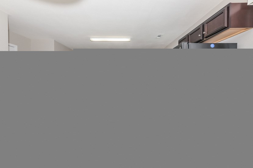 a large grey wall in a kitchen with a light on the ceiling