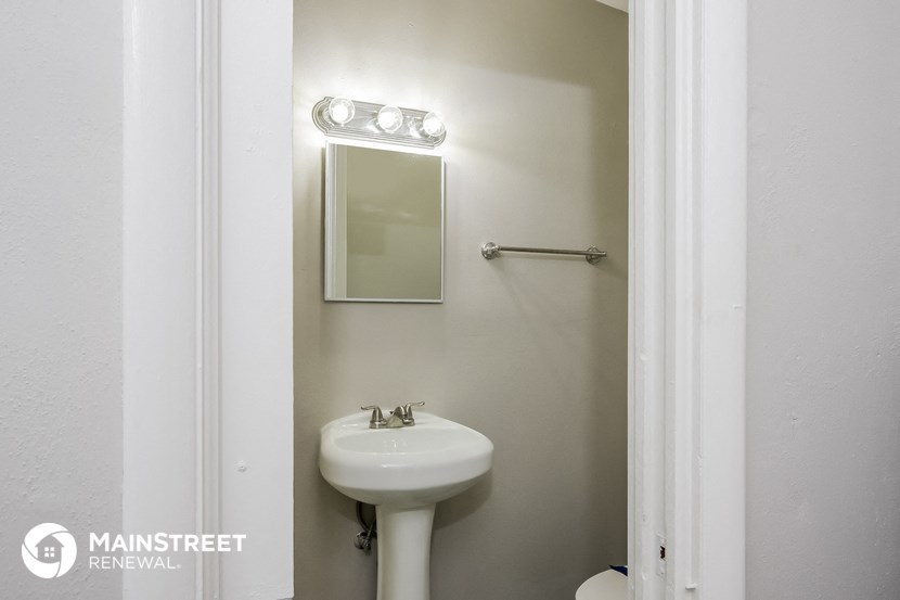 a small bathroom with a sink and a mirror