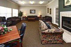 a living room with couches a table and a fireplace