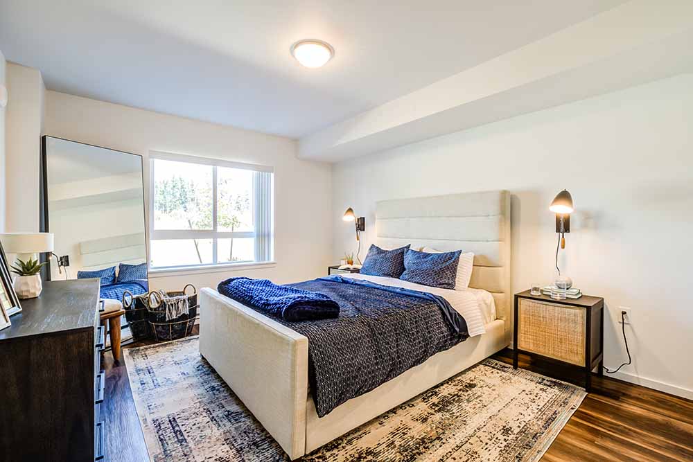 A bedroom with a large bed and a window.