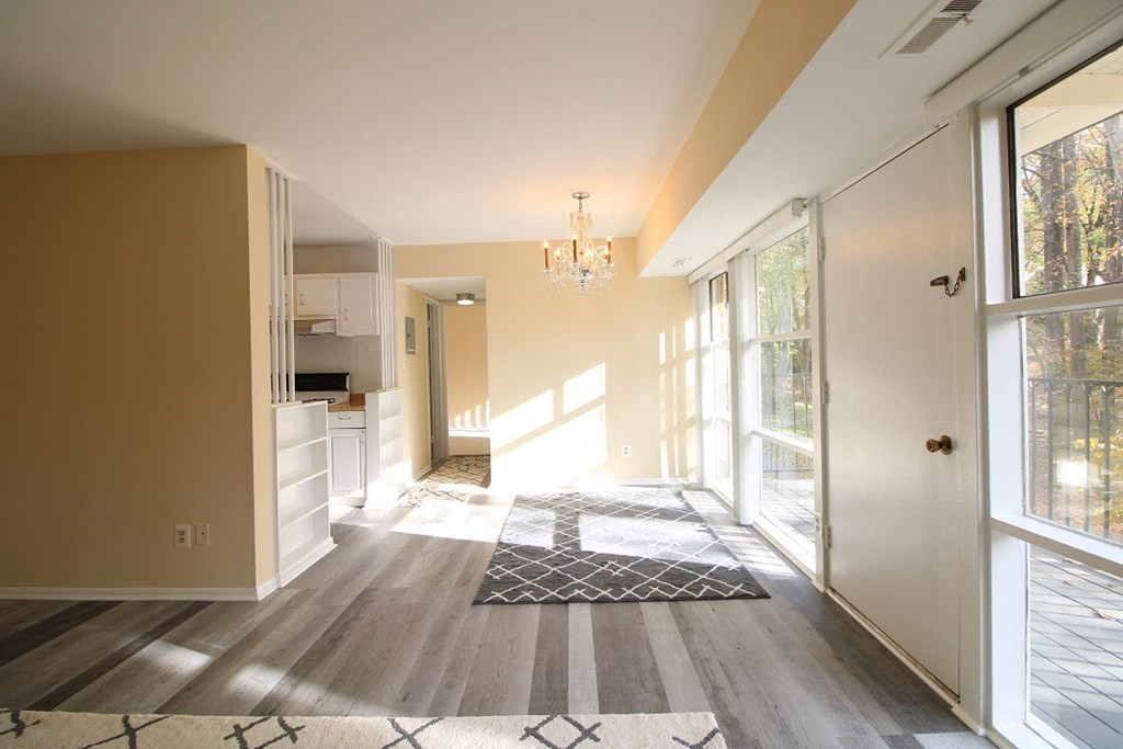 a view from the living room into the kitchen and dining room