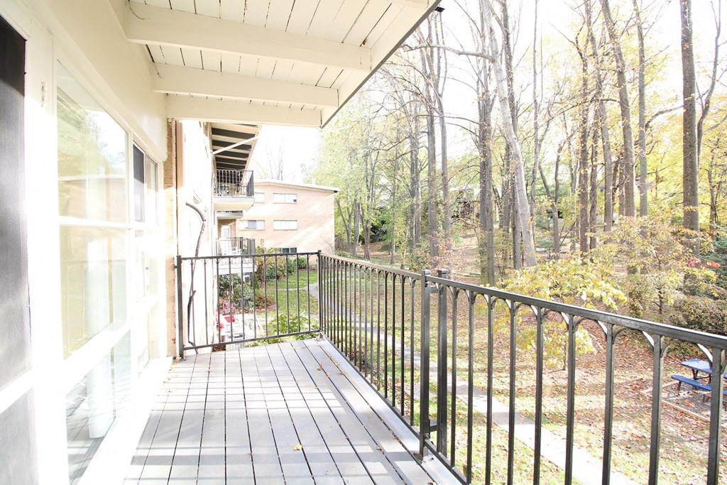 the view of the forest from the balcony of a home
