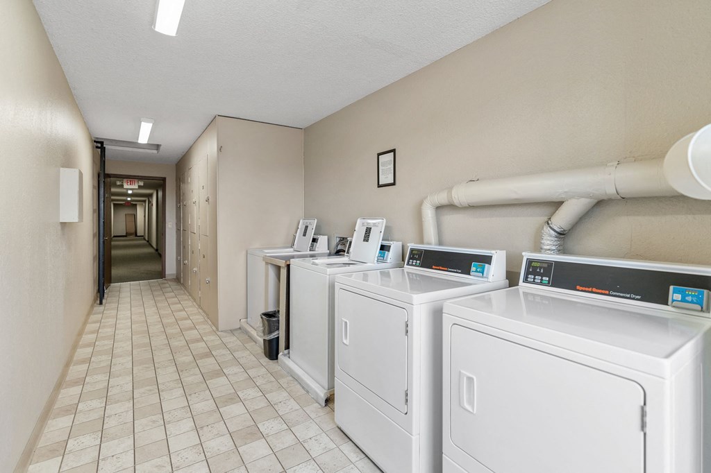 A laundry room with washers and dryers.