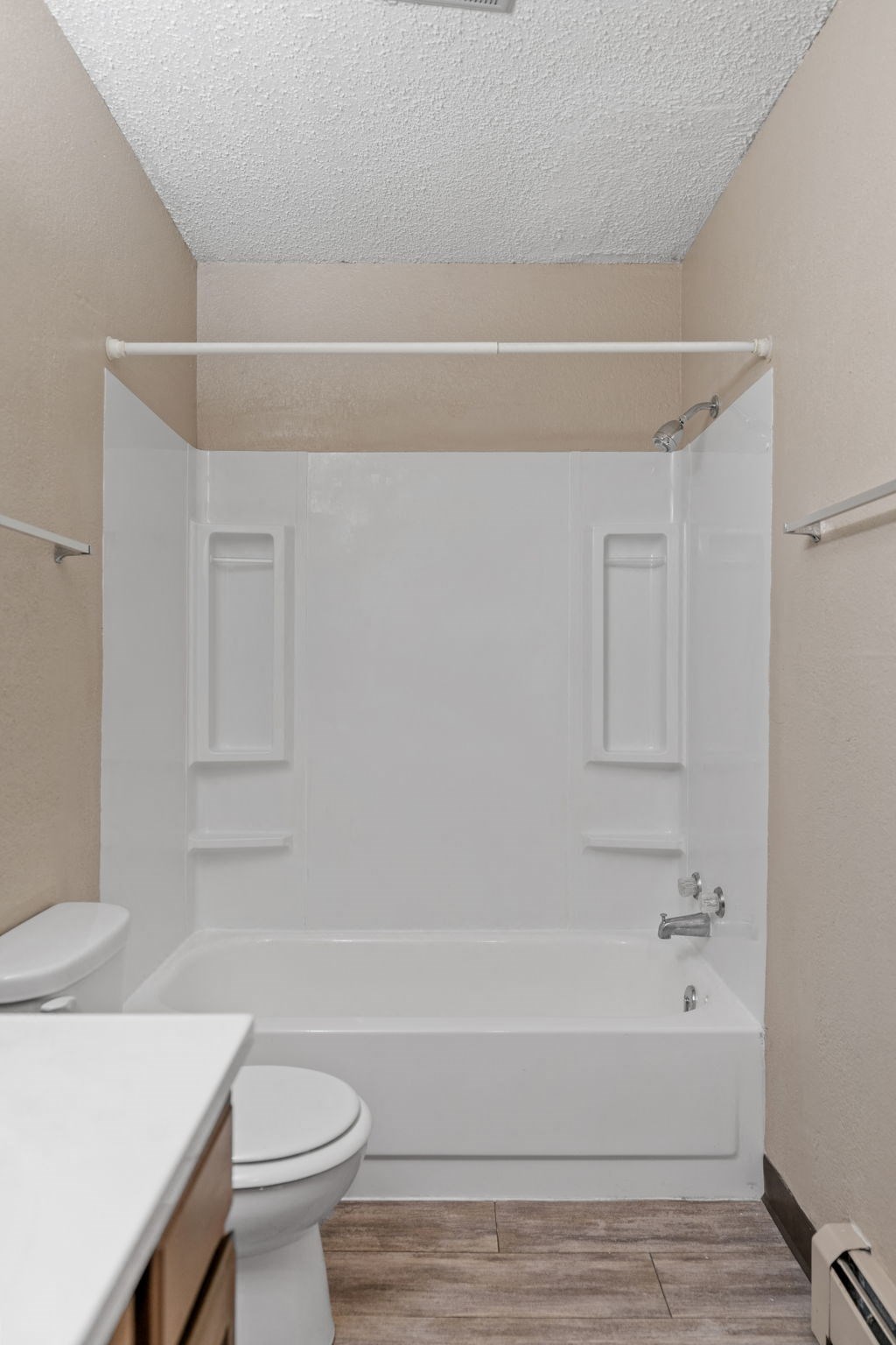 A white bathroom with a toilet, tub, and sink.