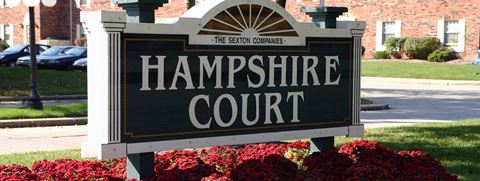 a sign for the hampshire court in front of a building