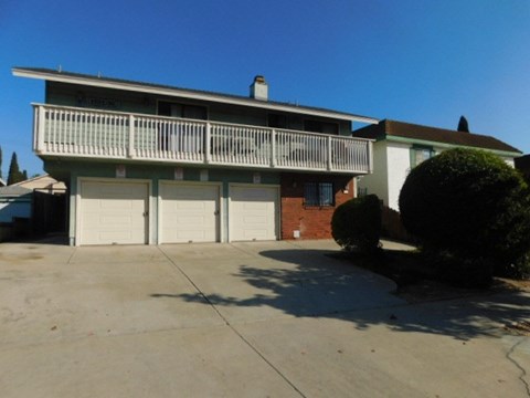 A two-story house with a balcony and a garage.