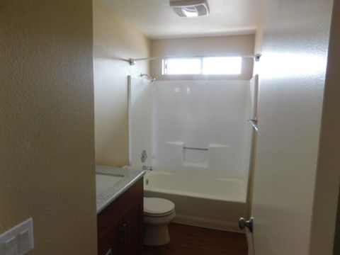 A bathroom with a toilet, sink, and shower.