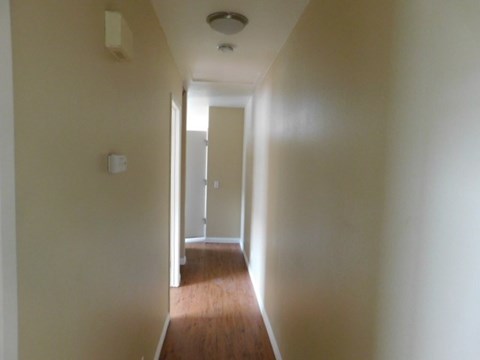 A long hallway with a door at the end.