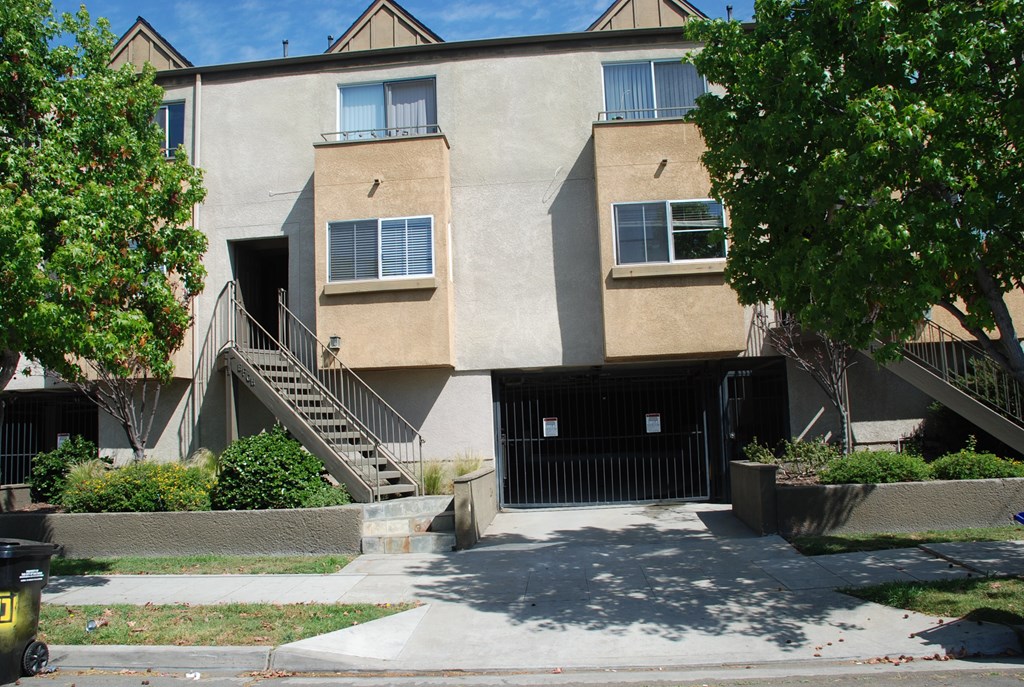 A concrete building with a black gate in front.