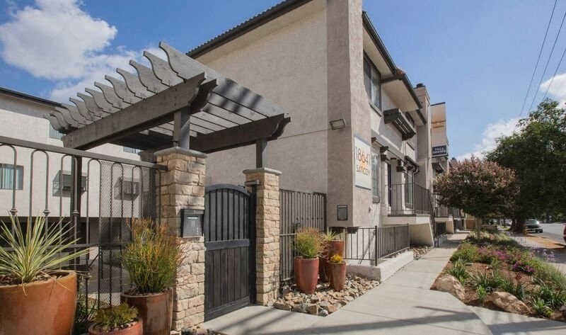 a building with a fence and a gate in front of it