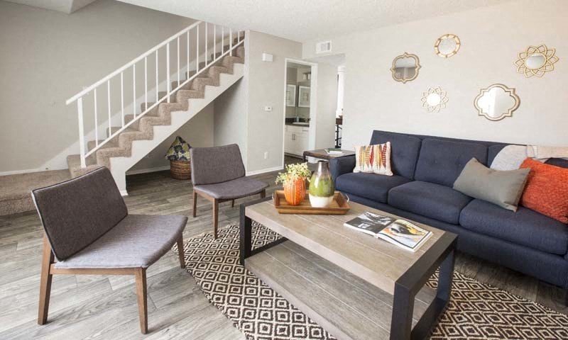 a living room with a blue couch and a table