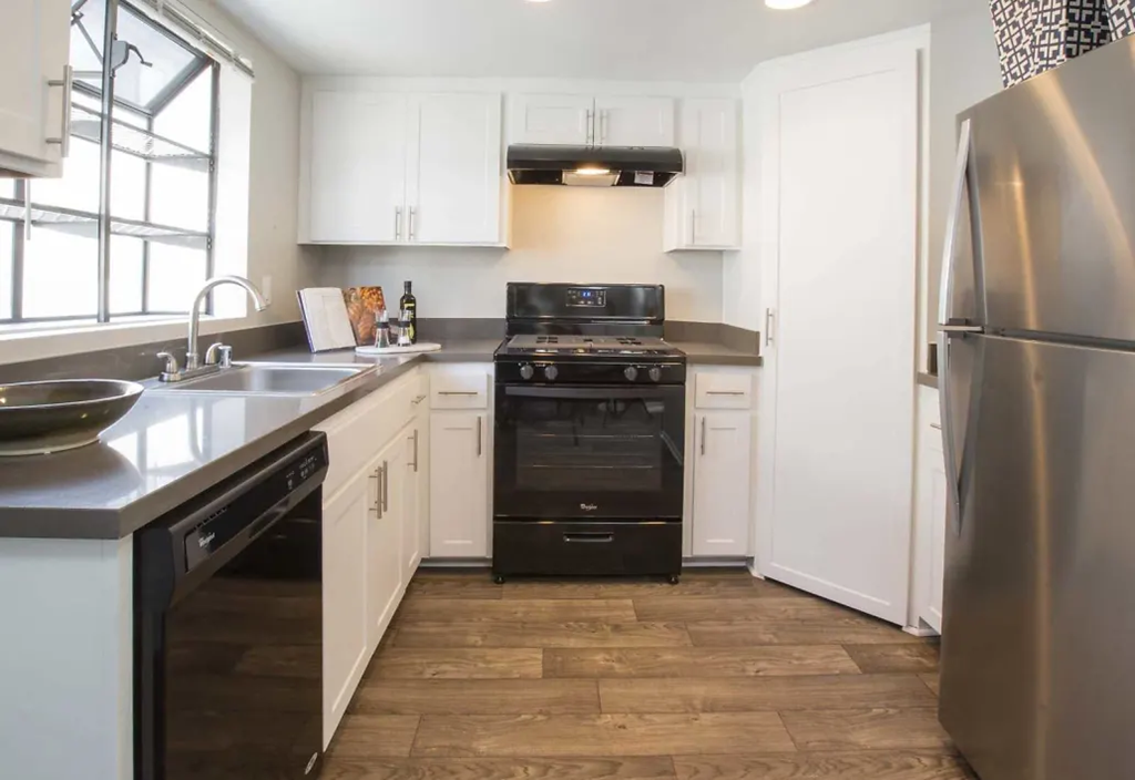 a kitchen with a stove and a sink and a refrigerator