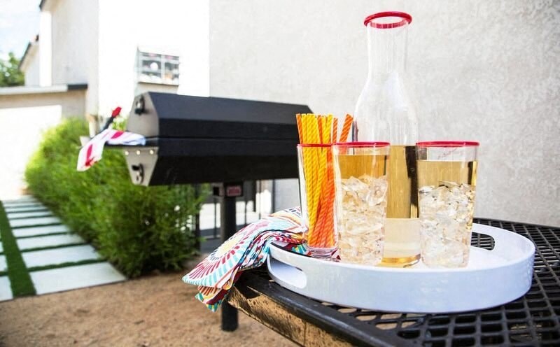 a table with two glasses and a bottle on it