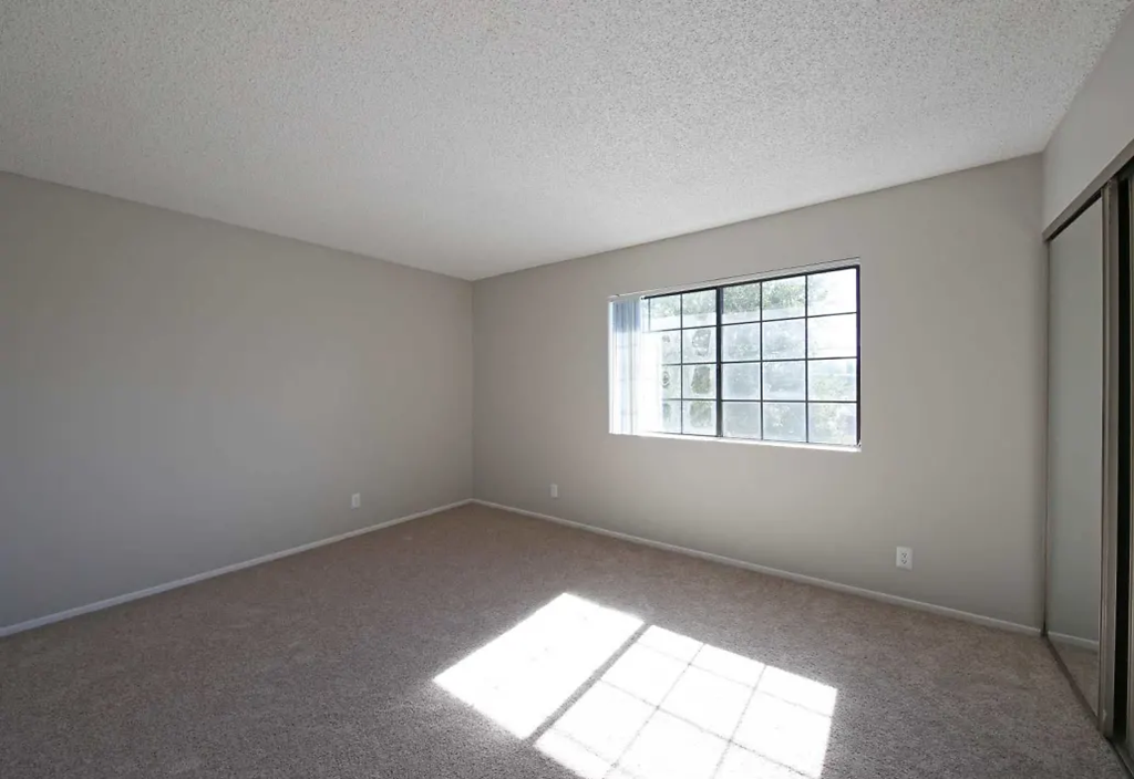the living room of an empty house with a window