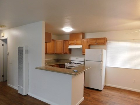 a kitchen with a stove and a refrigerator