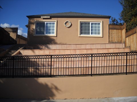 A house with a black fence in front of it.