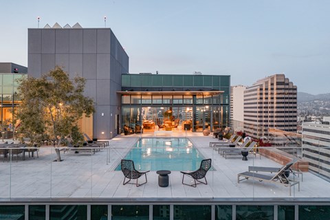 a swimming pool on the roof of a building in the city