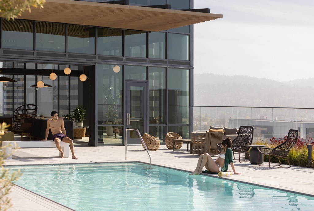 a man and a woman swimming in a swimming pool