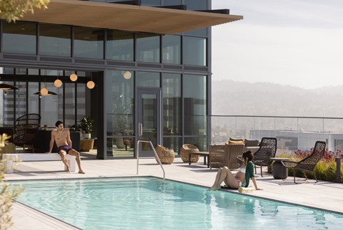 a man and a woman swimming in a swimming pool