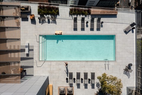 an aerial view of a pool on the side of a building