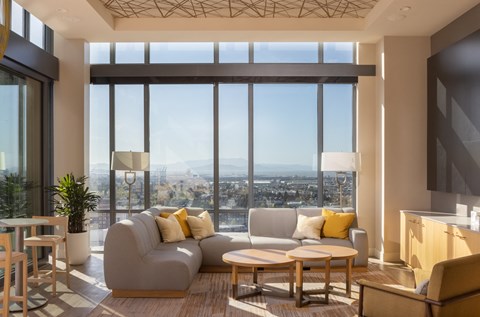 a living room with a couch and a view of the city