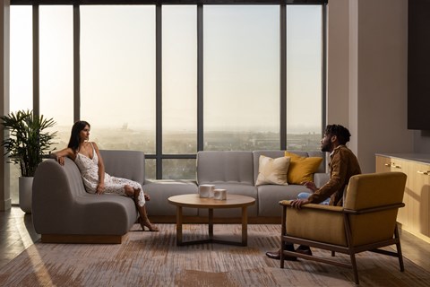 two people sitting on couches in a living room